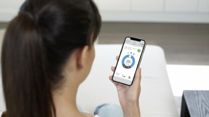 Lady using controller app after split system air conditioner installation